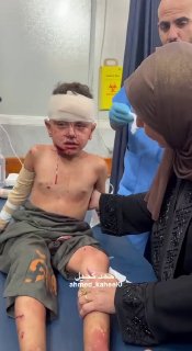 A Palestinian child cries after his mother was killed and he was injured in an Israeli airstrike on Al-Yaman Al-Sa'id Ho